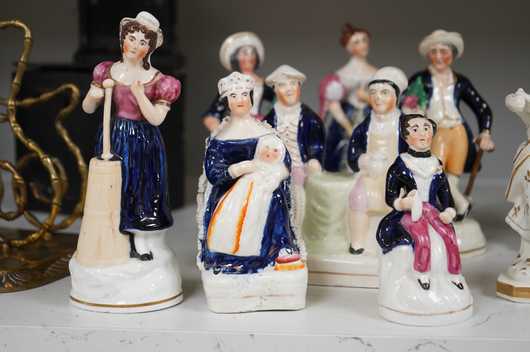 A group of mid-19th century Staffordshire porcelain figures, two models of zebras and a early 19th century Derby biscuit porcelain figure of a seated lady, largest 18cm high